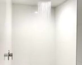 Guest bathroom with shower at Ramsey Inn & Suites.
