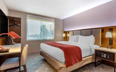 Day use room with work desk and natural light at Comfort Inn JFK Airport.