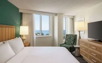 Romantic king room with TV at Embassy Suites By Hilton Deerfield Beach Resort & Spa.