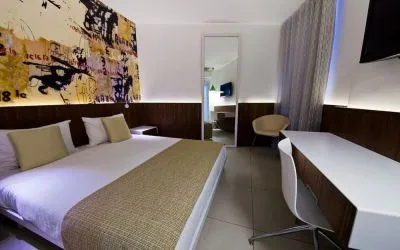King room with TV and work station at Prima Vera Hotel.