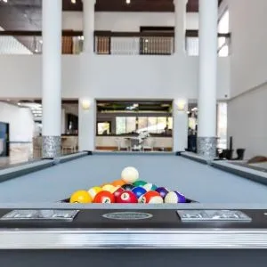 Game room and pool table at Regency Miami Airport By Sonesta.