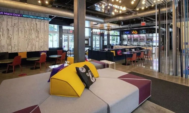 Lobby and seating area at Aloft Miami Doral.
