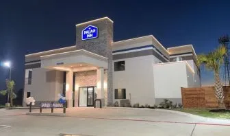 Hotel exterior at night at Palace Inn Blue Jones Rd. 