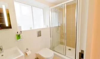 Guest bathroom with shower at The Wesley Euston Hotel.