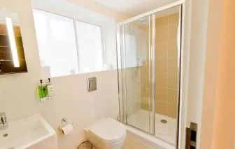 Guest bathroom with shower at The Wesley Euston Hotel.
