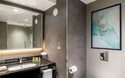 Guest bathroom with shower at Hilton Garden Inn London Heathrow Terminals 2 And 3.