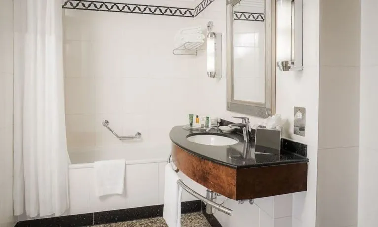Guest bathroom with shower at Hilton London Paddington.