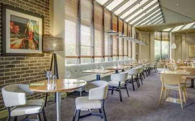 Spacious dining room with natural light at DoubleTree By Hilton Manchester Airport.