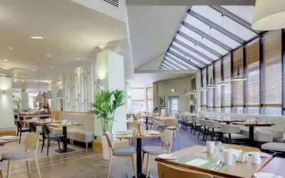 Spacious dining room with natural light at DoubleTree By Hilton Manchester Airport.