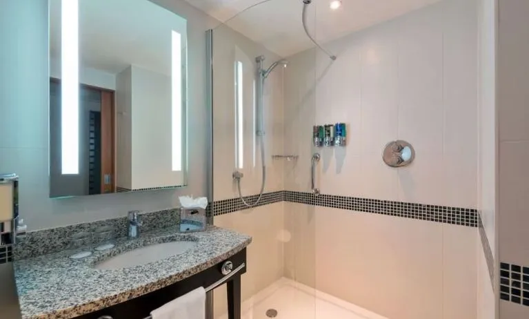 Guest bathroom with shower at Hampton By Hilton London Luton Airport.