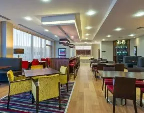 Dining area perfect for coworking at Hampton By Hilton London Luton Airport. 