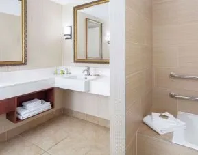 Guest bathroom with tub at DoubleTree By Hilton Sunrise.