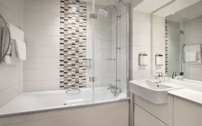 Guest bathroom with shower and tub at Leonardo Hotel Chester.