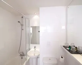 Guest bathroom with shower at Leonardo Inn Glasgow West End. 