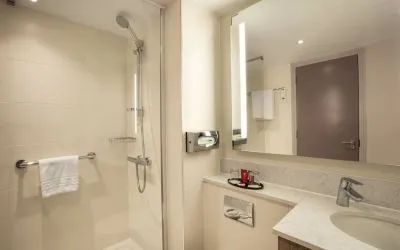 Guest bathroom with shower at Leonardo Hotel London Heathrow Airport.