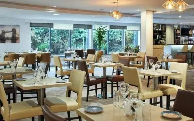 Dining area perfect for coworking at Leonardo Hotel London Heathrow Airport.