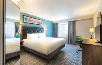 Day use room with tv and work desk at Leonardo Hotel Plymouth.