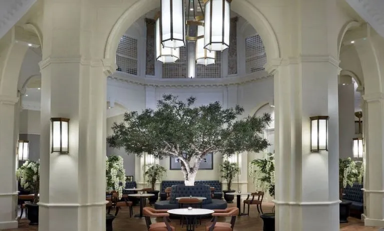 Bright lobby with arches and greeneries at The Midland - A Leonardo Royal Hotel.  