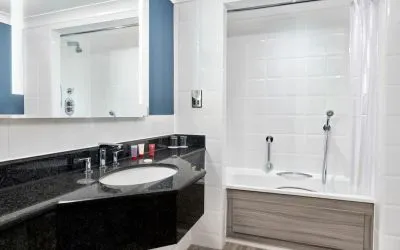 Guest bathroom with shower and tub at Leonardo Hotel Southampton Grand Harbour.