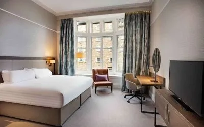 King bedroom with large window at Hilton Edinburgh Carlton.