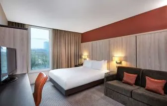 Day use room with sofa and large window at DoubleTree By Hilton London Excel.