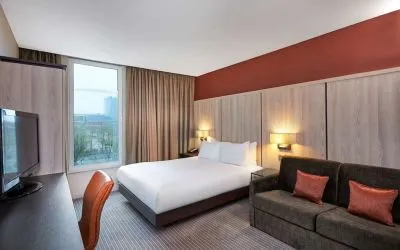 Day use room with sofa and large window at DoubleTree By Hilton London Excel.