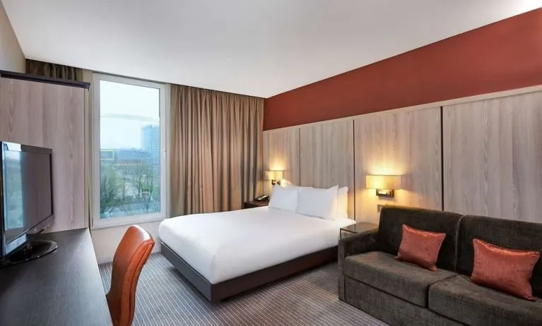 Day use room with sofa and large window at DoubleTree By Hilton London Excel.