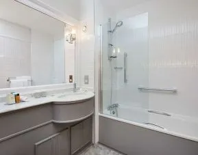 Guest bathroom with shower and tub at DoubleTree By Hilton Coventry.