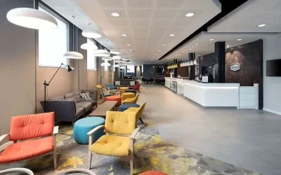 Spacious hotel lobby with lounge area, perfect for co-working at the Hampton by Hilton London Docklands.