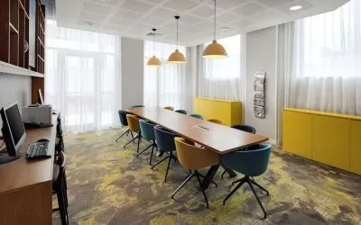 Business center with table, computer and printer at the Hampton by Hilton London Docklands.