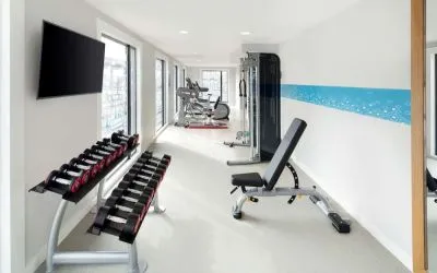 Bright fitness center with machines and equipment at the Hampton by Hilton London Docklands.