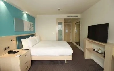Day use room with TV and workdesk at the Hampton by Hilton London Docklands.