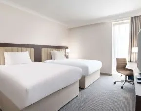 Double guest room with TV screen and desk at the Hilton London Gatwick Airport.