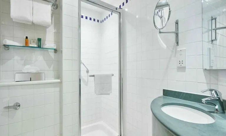 Guest bathroom with shower and toiletries at the Hilton Garden Inn Birmingham Brindleyplace.