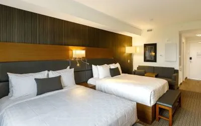 Twin bed day use room with sofa, work desk and private bathroom at Executive Residency By Best Western.