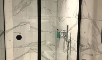 Guest bathroom with shower at Euston Square Hotel.