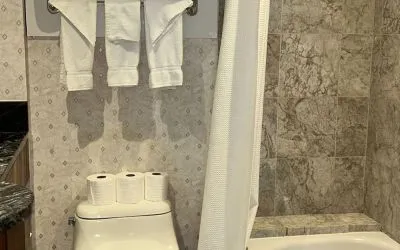 Private guest bathroom with tub at Parc Suites Hotel.