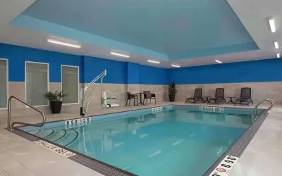 Relaxing indoor pool with lounge area at Hampton Inn By Hilton Port Hope.