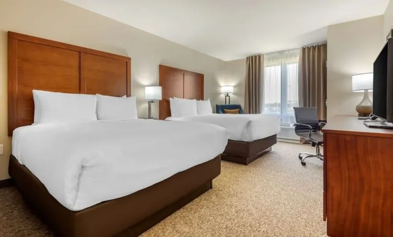 Day use twin room with TV, sofa and work desk at Comfort Inn & Suites Napanee.
