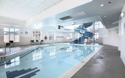 Indoor pool with lounge chairs at Holiday Inn Express & Suites Airport-Calgary.