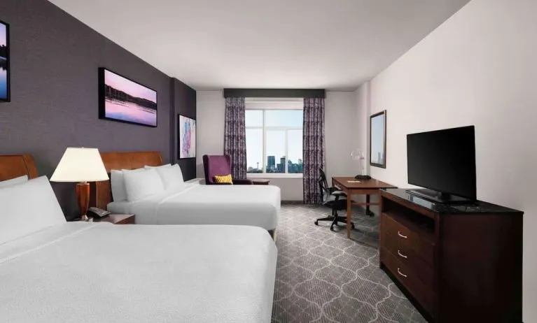 Comfortable twin room with TV, work desk and private bathroom at Hilton Garden Inn Calgary Airport.