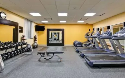 Fully equipped fitness center with treadmills and weights at the Hampton Inn by Hilton Toronto Airport Corporate Centre.