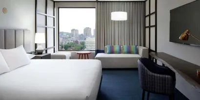 Day use room with work desk, lounge area and window view at DoubleTree By Hilton Montreal.