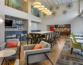 Hotel dining area with comfortable seating, perfect for co-working at Hampton Inn & Suites By Hilton Edmonton/West.