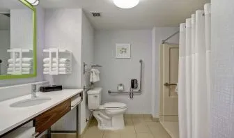 Private guest bathroom with shower and free toiletries at the  Hampton Inn & Suites By Hilton Guelph.