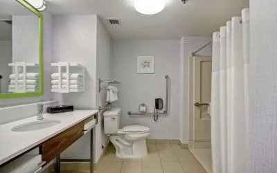 Private guest bathroom with shower and free toiletries at the  Hampton Inn & Suites By Hilton Guelph.