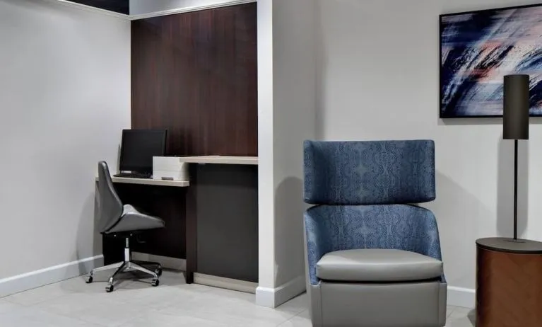 Business center with computer, printer and ergonomic chair at Courtyard By Marriott Edmonton Downtown.