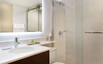 Private guest bathroom with shower and free toiletries at DoubleTree By Hilton Hotel Toronto Airport West.