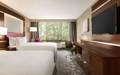 Day use twin room with large windows, TV, sofa, work desk and private bathroom at DoubleTree By Hilton Hotel Toronto Airport West.