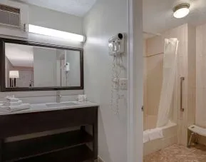 Private guest bathroom with shower and free toiletries at Days Inn Vernon.